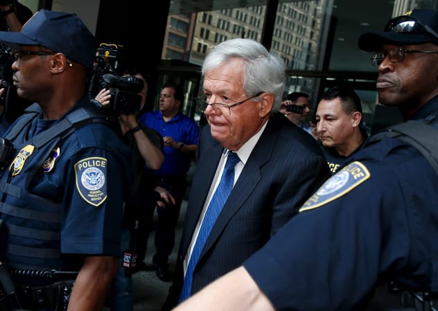 Former US House of Representatives Speaker Dennis Hastert is surrounded by officers as he leaves federal court after pleading not guilty to federal charges of trying to hide large cash transactions and lying to the FBI in Chicago, Illinois, United States, June 9, 2015.