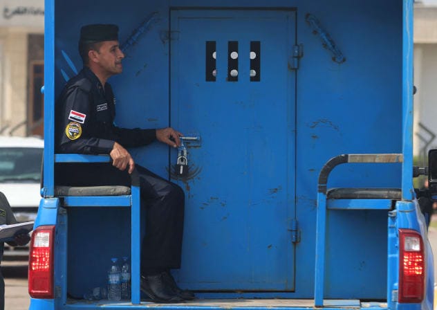 An Iraqi police patrol transports Iraqi detainees to the Karkh Court during the trial of six French citizens accused of terrorism in Baghdad, on October 5, 2026; Illustrative.