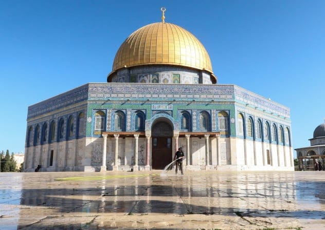 An Islamic Waqf member cleans the area outside the Dome of the Rock, at Al-Aqsa compound, in Jerusalem, September 13, 2026.
