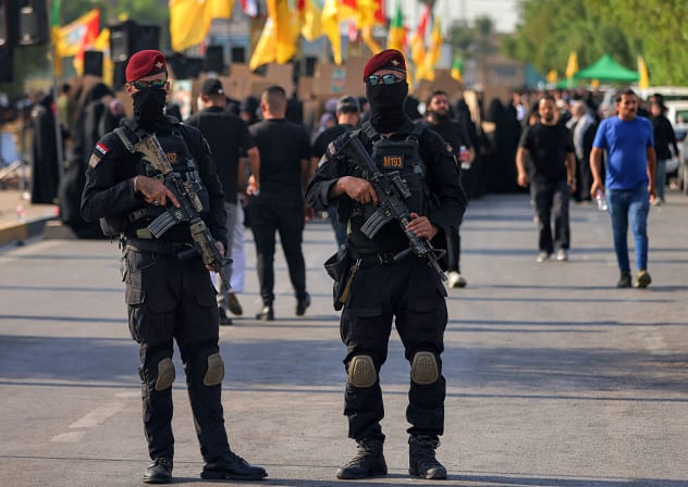 Iraqi security forces stand guard during a rally celebrating the withdrawal of forces of the US-led coalition against the Islamic State from Iraq in Baghdad on September 30, 2026.