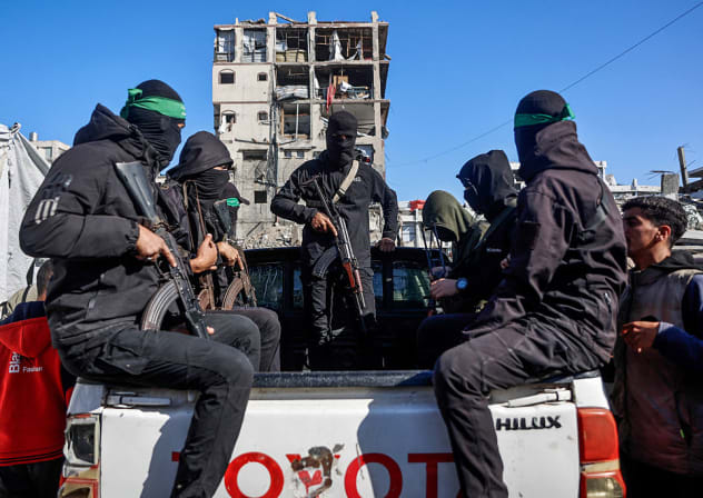Hamas terrorists arrive to secure the area search for the last two remaining bodies of hostages - an Israeli soldier and a Thai national - from under the rubble of the Jabalia refugee camp, in the northern of Gaza Strip on December 1, 2025. as Egyptian workers accompanied by members of the ICRC 