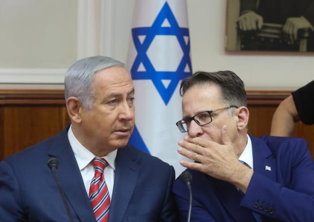 Israeli prime minister Benjamin Netanyahu (L) speaks with Cabinet secretary Tzachi Braverman during the weekly government conference at the Prime Minister's Office in Jerusalem on June 17, 2018