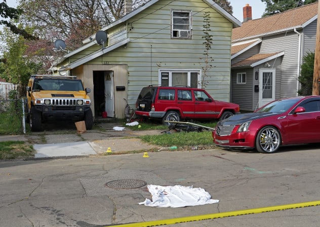 A bloodied sheet lies behind police barrier tape at a house where nine people were confirmed dead in what was described as a mass shooting in Erie, Pennsylvania, US October 10, 2026.