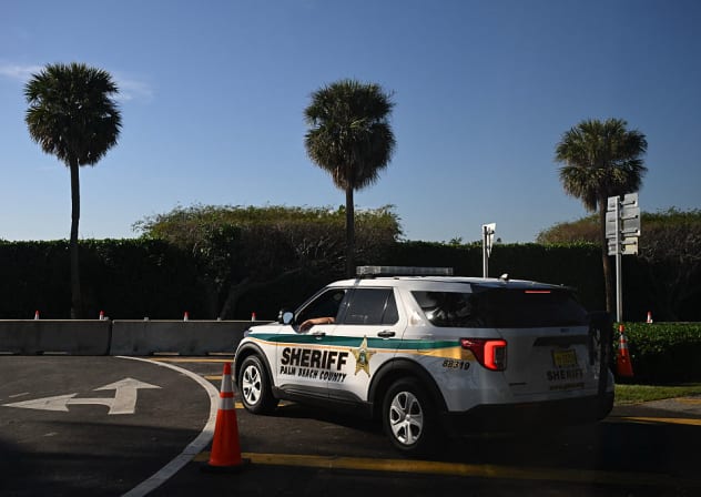 Illustrative:  member of the Palm Beach County Sheriffs' office parks a patrol car outside of Mar-a-Lago club as part of the security for US President Donald Trump in Palm Beach, Florida on December 20, 2025. 