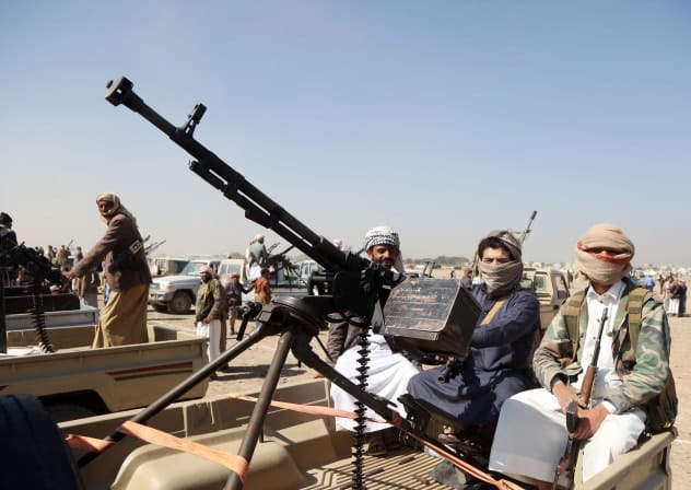 Houthi fighters man machine guns mounted on trucks as they participate in a weaponized protest staged against the US and Israel on November 6, 2025, in Sanaa.