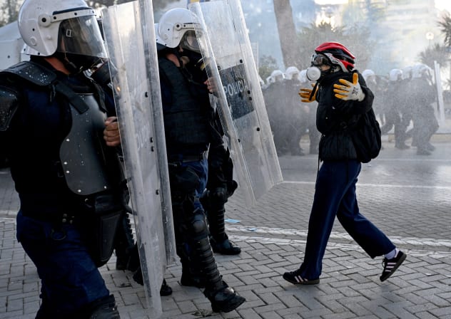 A protester faces off with a police unit during an anti-government demonstration in central Tirana on October 17, 2026, as protests continued for a fifth consecutive day over university conditions and demands for the resignation of Albanian Prime Minister Edi Rama.