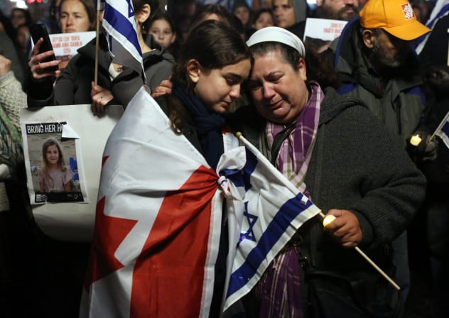 A mother and daughter embrace as members of the Jewish community hold a vigil for the victims of October 7, on Parliament Hill in Ottawa, Ontario, Canada, on October 28, 2023
