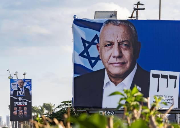 Election campaign billboards featuring Yashar party chairman Gadi Eisenkot and Likud party chairman and Israeli Prime Minister Benjamin Netanyahu alongside opposition leaders are displayed along a roadside in the northern Israeli city of Haifa, ahead of Israel’s upcoming general elections, October 1