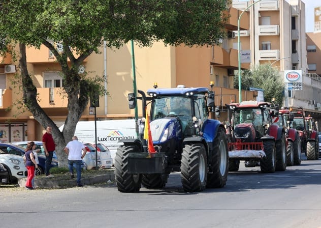 Tractors drive past a petrol station during a farmers' protest against high fuel and production costs, in Gela, Sicily, Italy, October 3, 2026.