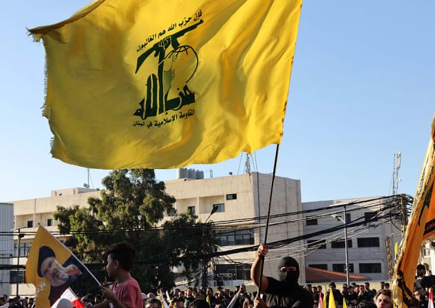 Supporters of Lebanese Shia movement Hezbollah wave flags of the group during a ceremony held to mark the second anniversary of the killing of leader Hassan Nasrallah in a strike by Israel, in Beirut's southern suburbs on September 27, 2026. 