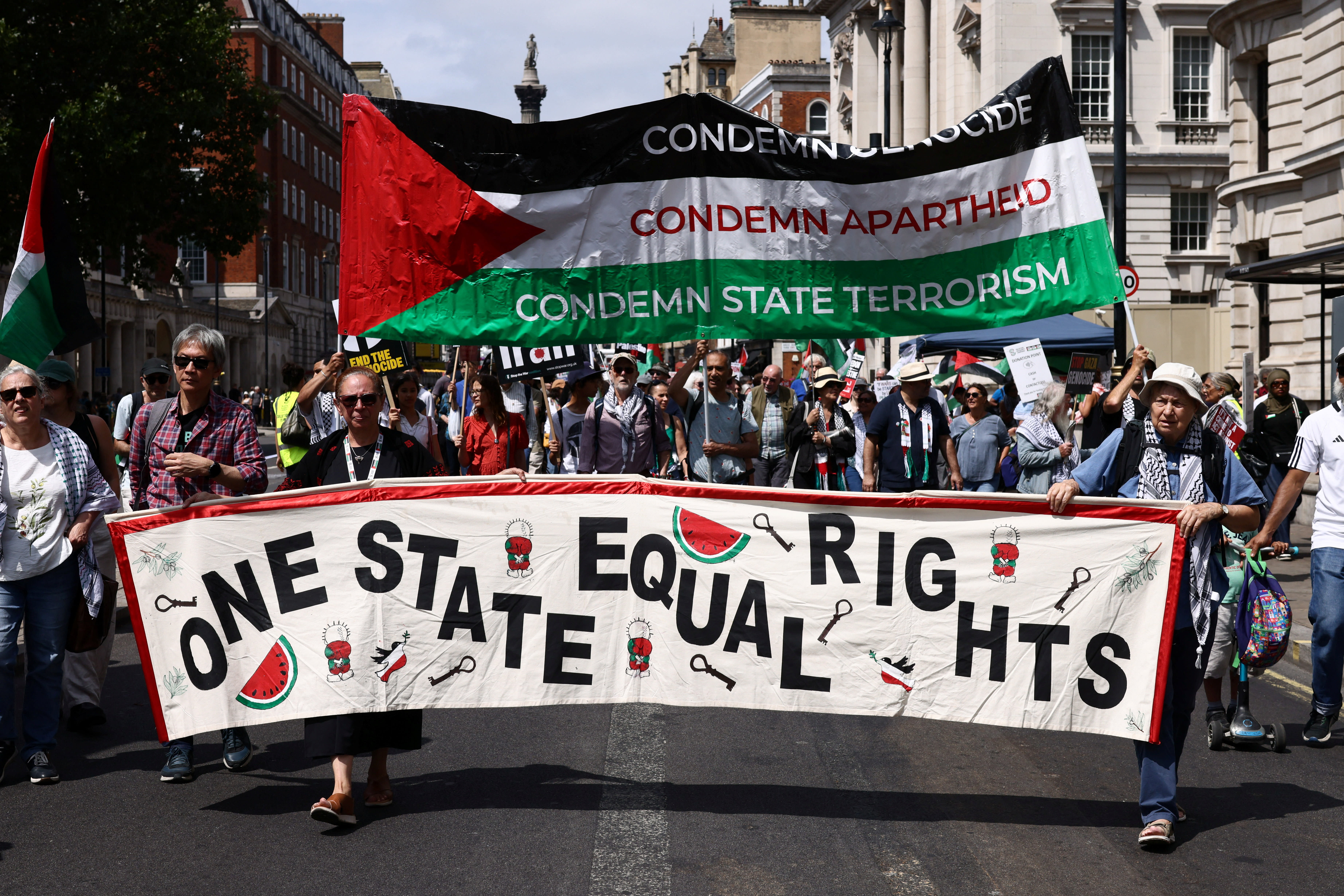 People carry a banner down Whitehall during a "National March for Palestine" calling on Britain