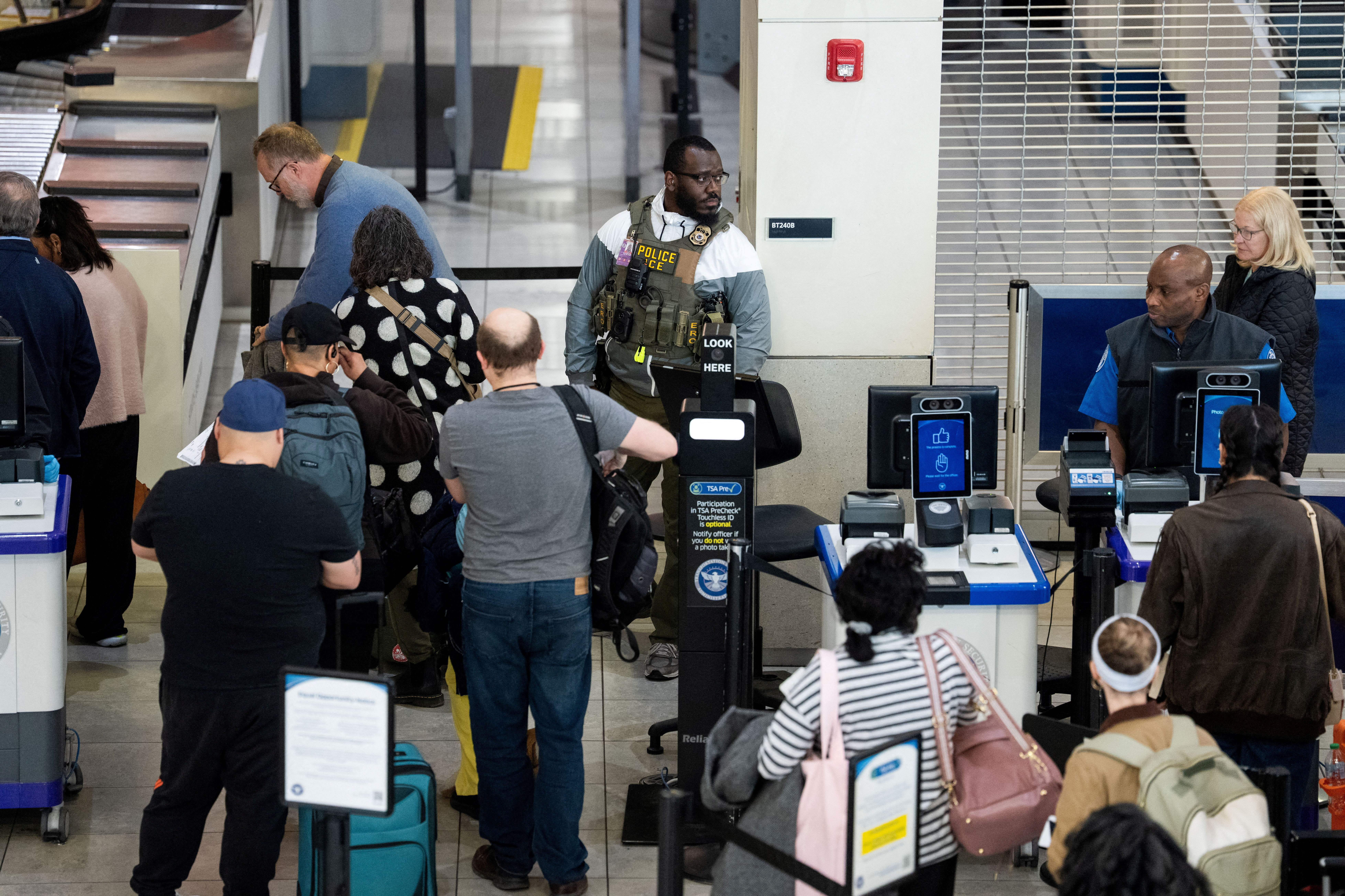A US Immigration and Customs Enforcement (ICE) agent patrols a TSA security checkpoint in Baltimore/Washington International Thurgood Marshall Airport (BWI) in Baltimore, Maryland, US, March 29, 2026.  (photo credit: REUTERS/AARON SCHWARTZ)