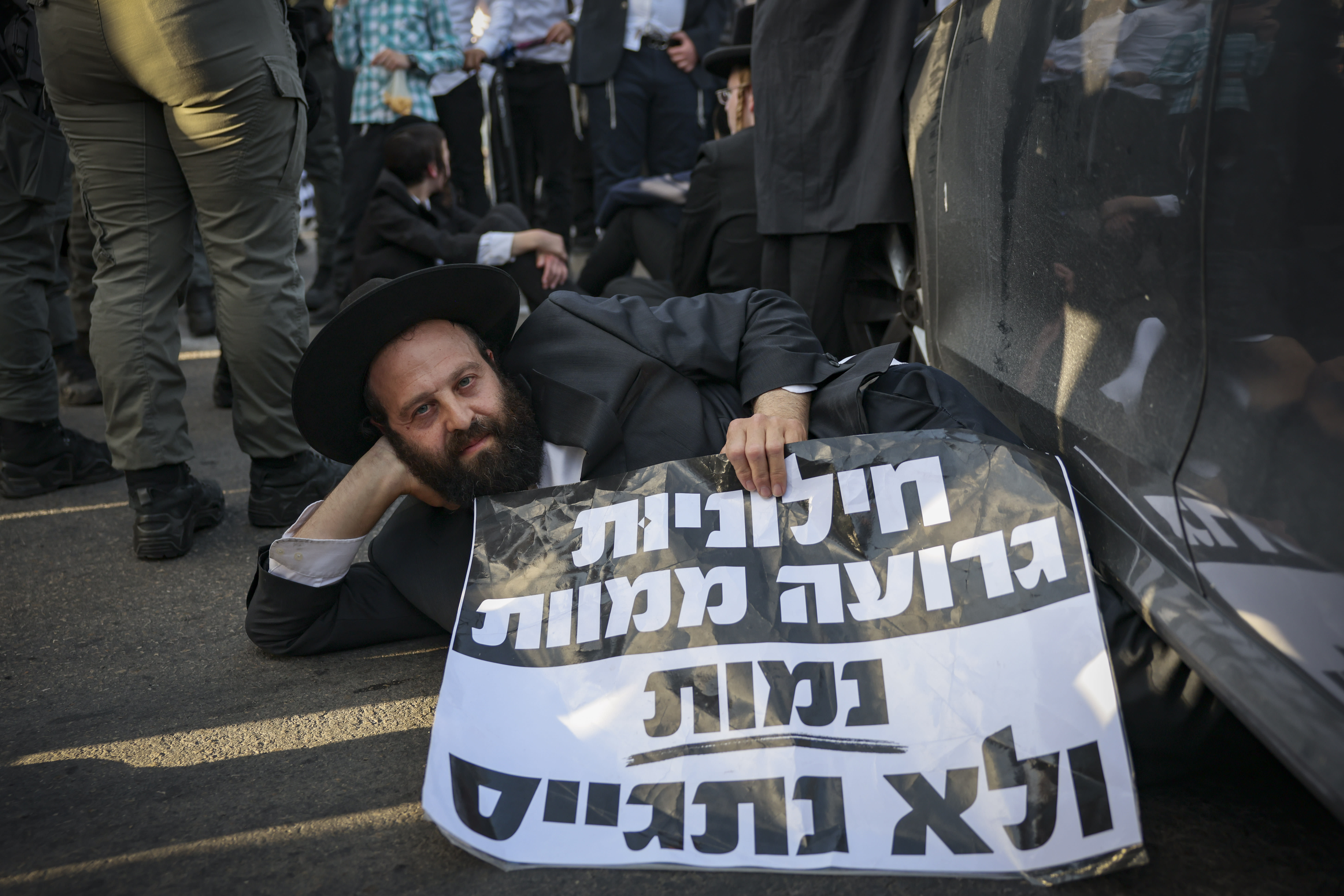 ULTRA-ORTHODOX Jewish men block a road during a protest against the jailing of seminary students who failed to comply with an army recruitment order in Bnei Brak, April 28, 2026. (photo credit: FLASH90)