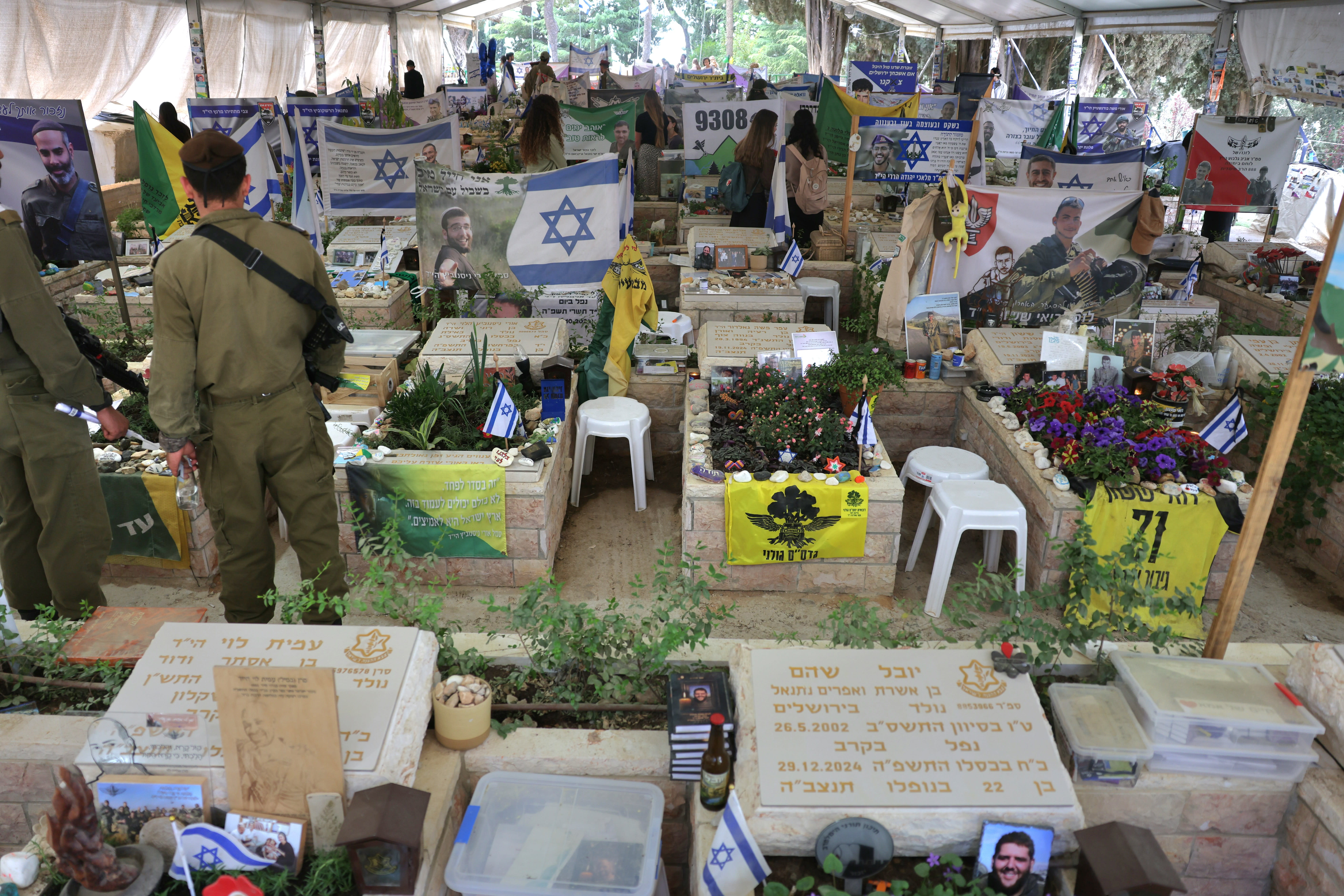 Soldiers stand in front a memorial to fallen soldiers in Jerusalem’s Mount Herzl Cemetery a few days ahead of Yom Hazikaron, Israel’s Remembrance Day.  (photo credit: MARC ISRAEL SELLEM)