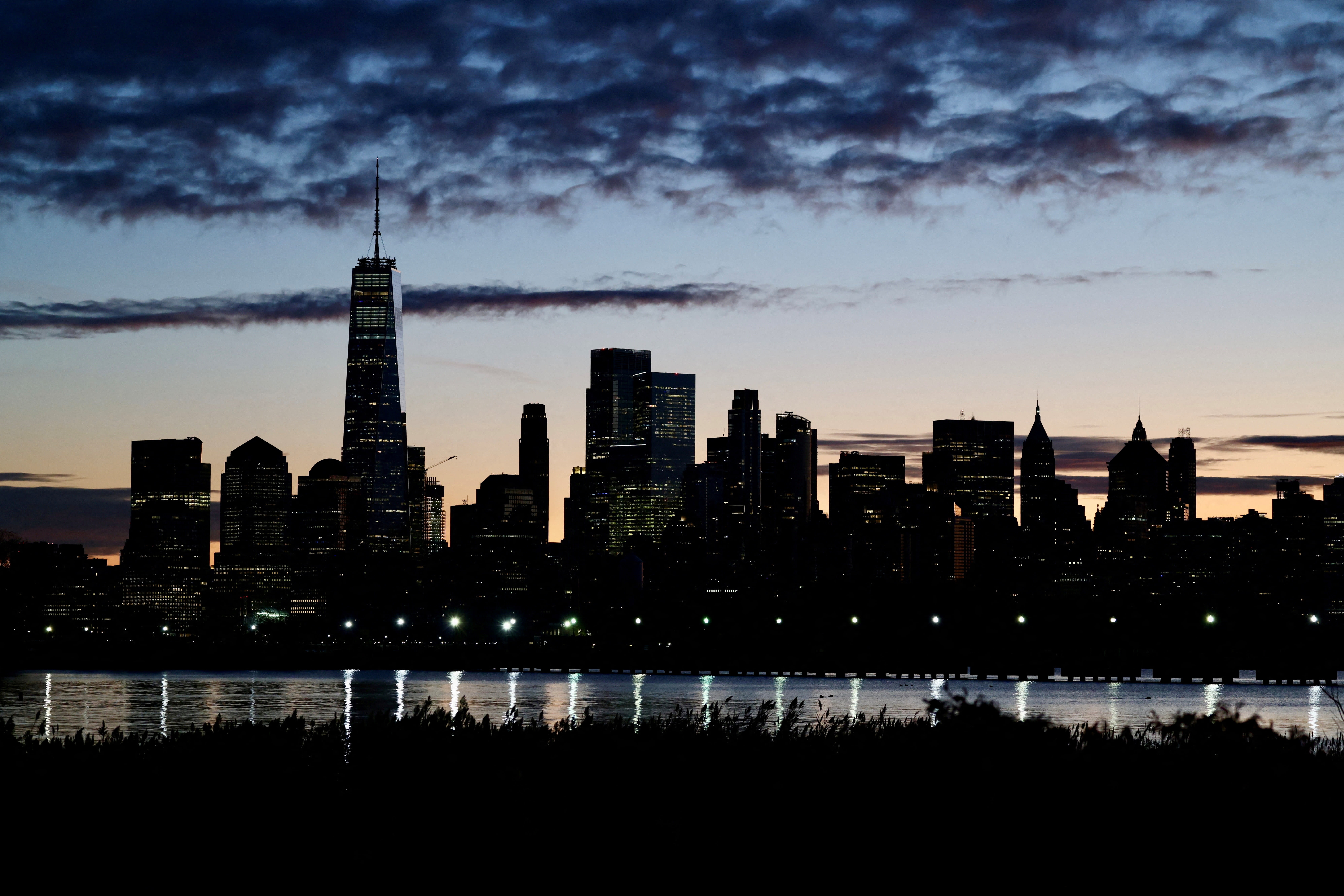 The skyline of Lower Manhattan is seen at dawn from across the Hudson River in New York City, US, October 18, 2025. (photo credit: REUTERS/KEVIN COOMBS/FILE PHOTO)