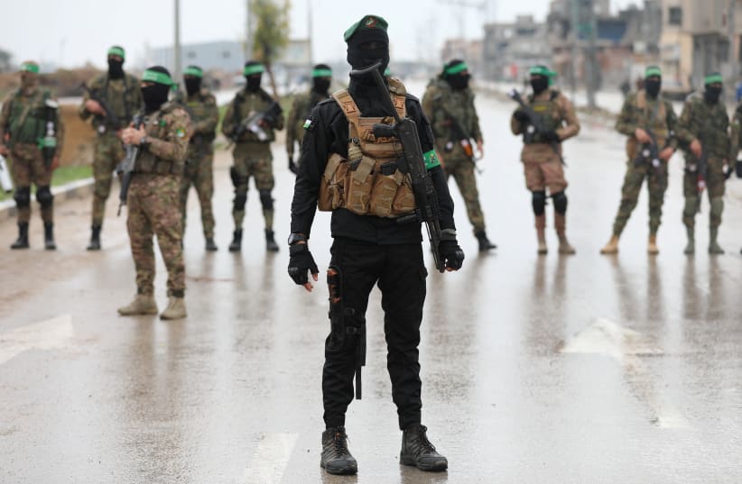  Palestinian Hamas militants stand guard on the day of the handover of hostages in Rafah in the southern Gaza Strip, February 22, 2025.