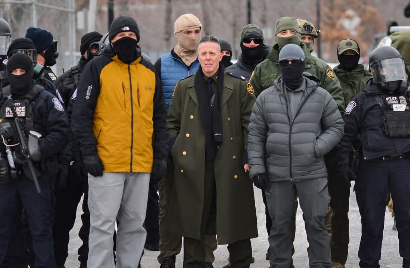US Customs and Border Protection Commander Gregory Bovino (C) stands flanked by fellow federal agents during a protest against ICE outside the Bishop Whipple Federal Building in Minneapolis, Minnesota, on Jan. 15, 2026. (photo credit: Octavio JONES / AFP)