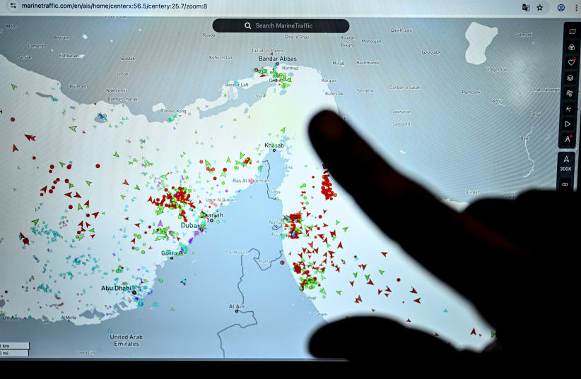 A person points at a page on the Marinetraffic website that shows commercial boats traffic on the edge of the Strait of Hormuz near the Iranian coast, in Paris on March 4, 2026.