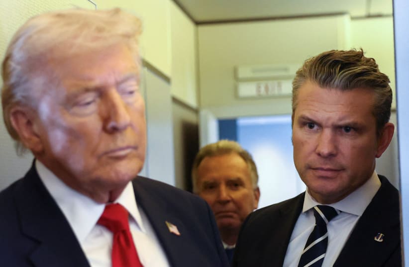 US President Donald Trump, with Secretary of Defense Pete Hegseth at his side, speaks to reporters aboard Air Force One on a flight from Dover, Delaware, to Miami, Florida, US, March 7, 2026