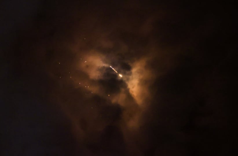 An Iranian missile flies over the city, amid the US-Israeli conflict with Iran, in Jerusalem, March 18, 2026. 