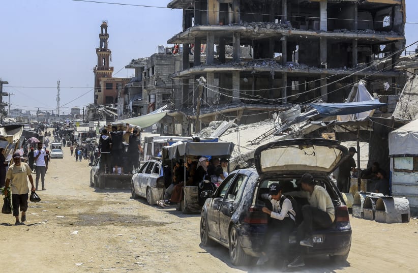 Palestinians live among buildings destroyed during the recent war in Khan Yunis, in the southern Gaza Strip, July 31, 2026.