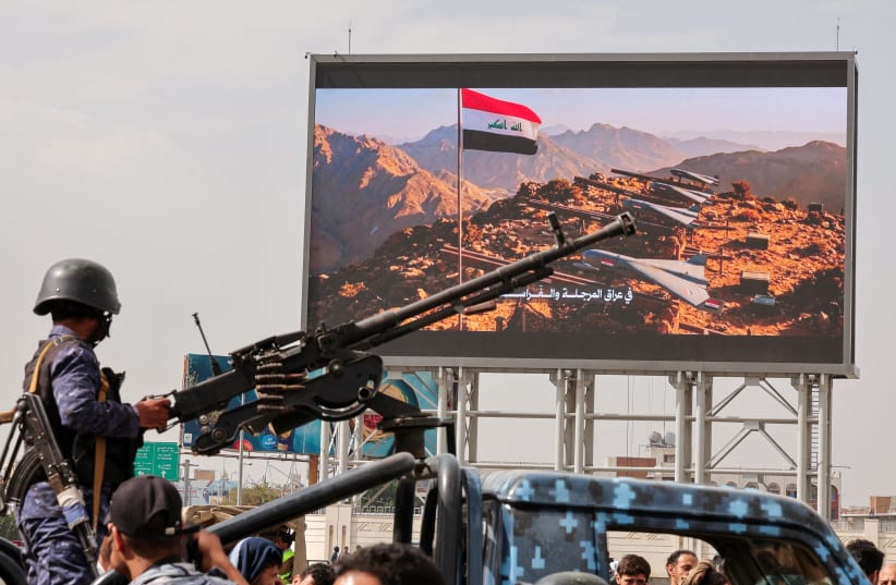 A member of Houthi security forces mans a machine gun mounted on the back of a patrol vehicle at the site of an anti-Saudi rally amid an escalation with the kingdom in Sanaa, Yemen, last month.  (photo credit: KHALED ABDULLAH/REUTERS)