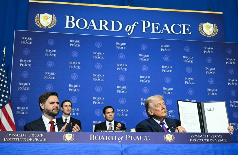 US Vice President JD Vance, Jared Kushner, and US Secretary of State Marco Rubio look on as US President Donald Trump holds up a resolution document that he signed during the inaugural meeting of the Board of Peace at the US Institute of Peace in Washington, DC, on February 19.  (photo credit: Saul Loeb/AFP via Getty Images)