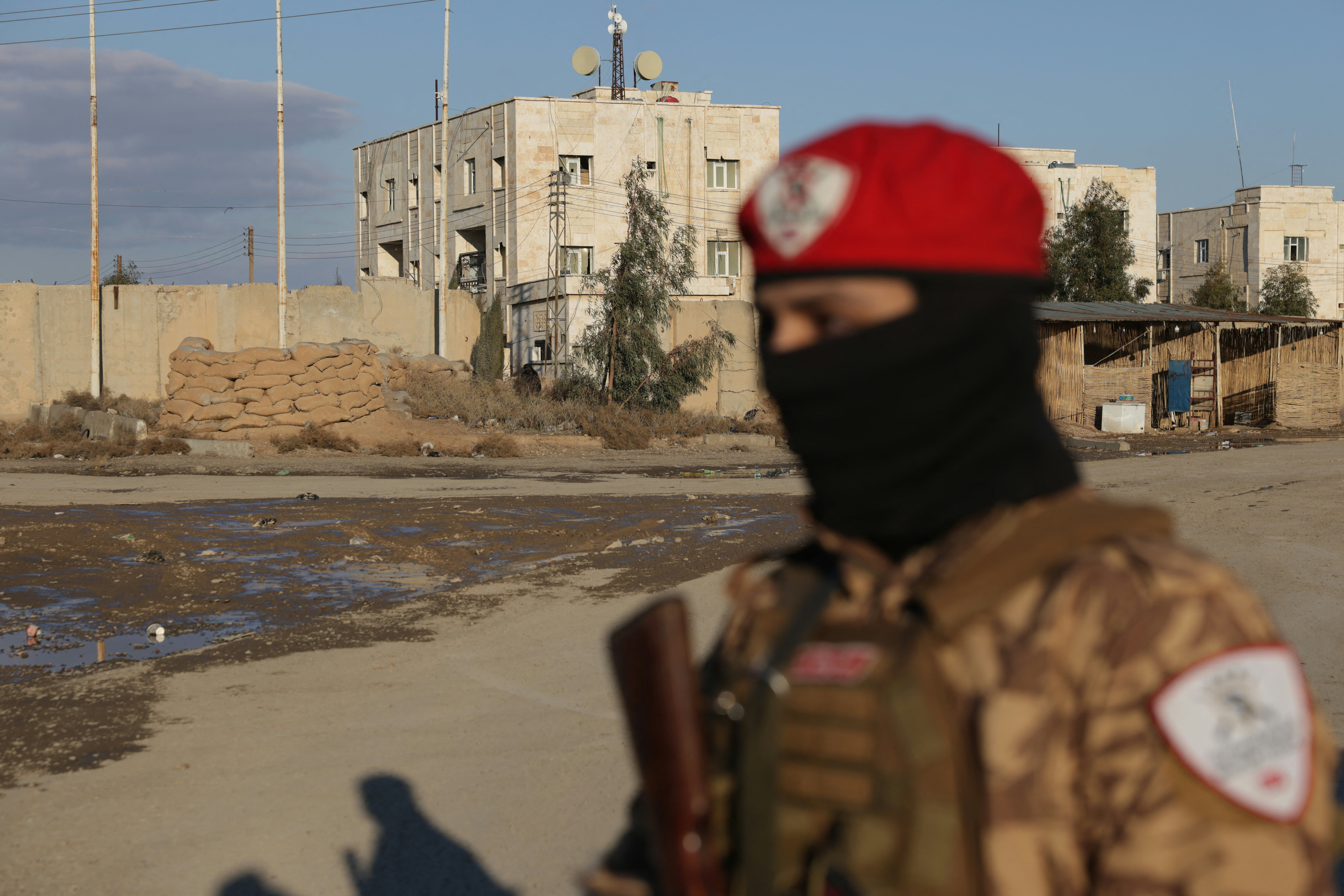 A Syrian government soldier stands outside SDF controlled Al Aktan prison which holds ISIS detainees, as the Syrian amry takes possession of the nearby SDF military base in the city of Raqa on January 19, 2026. (photo credit: Bakr ALKASEM / AFP via Getty Images)