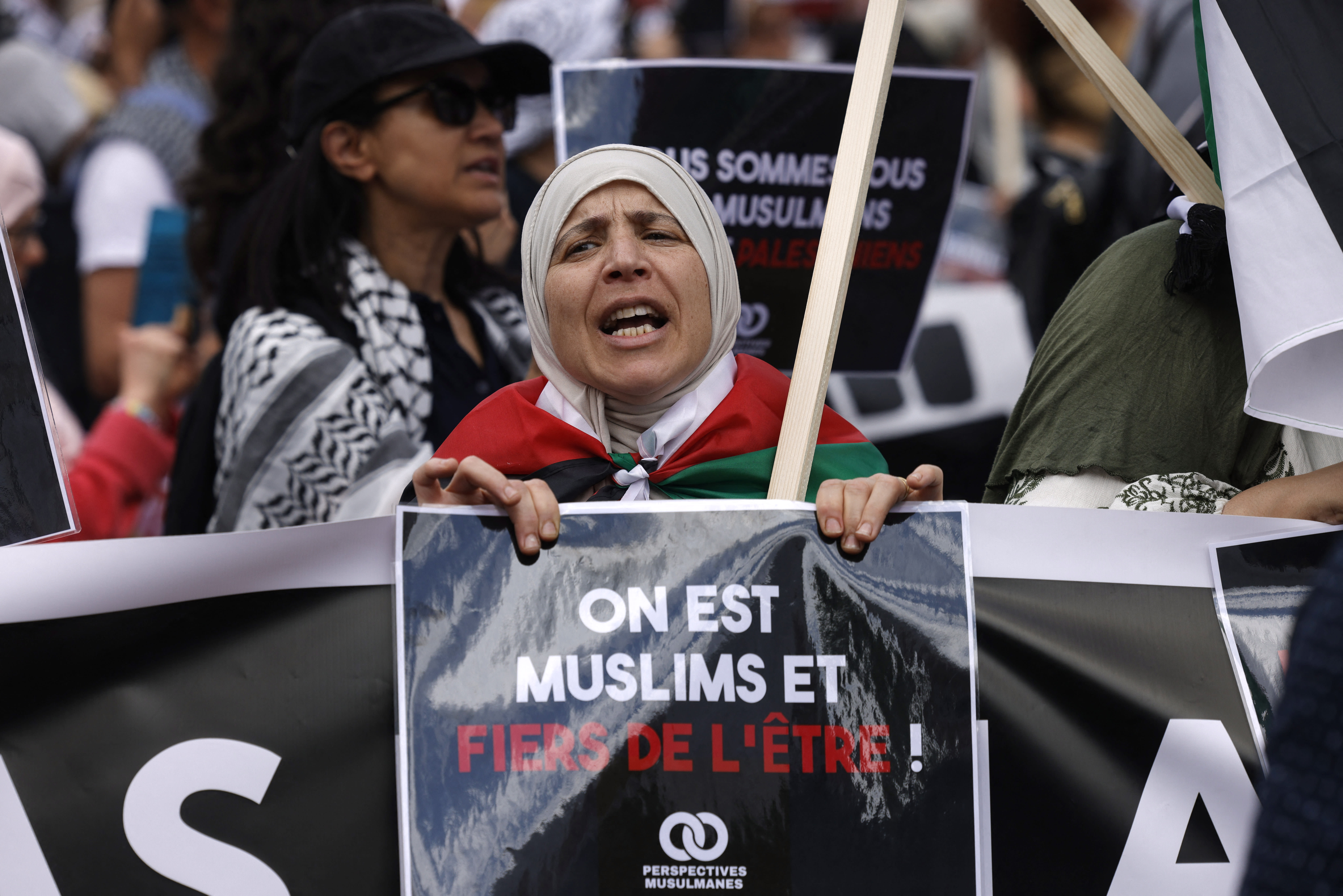 A protester holds a placard reading "we are Muslims and proud of it" during a rally against Islamophobia, in Paris on May 11, 2025.  (photo credit: GEOFFROY VAN DER HASSELT/AFP VIA GETTY IMAGES)