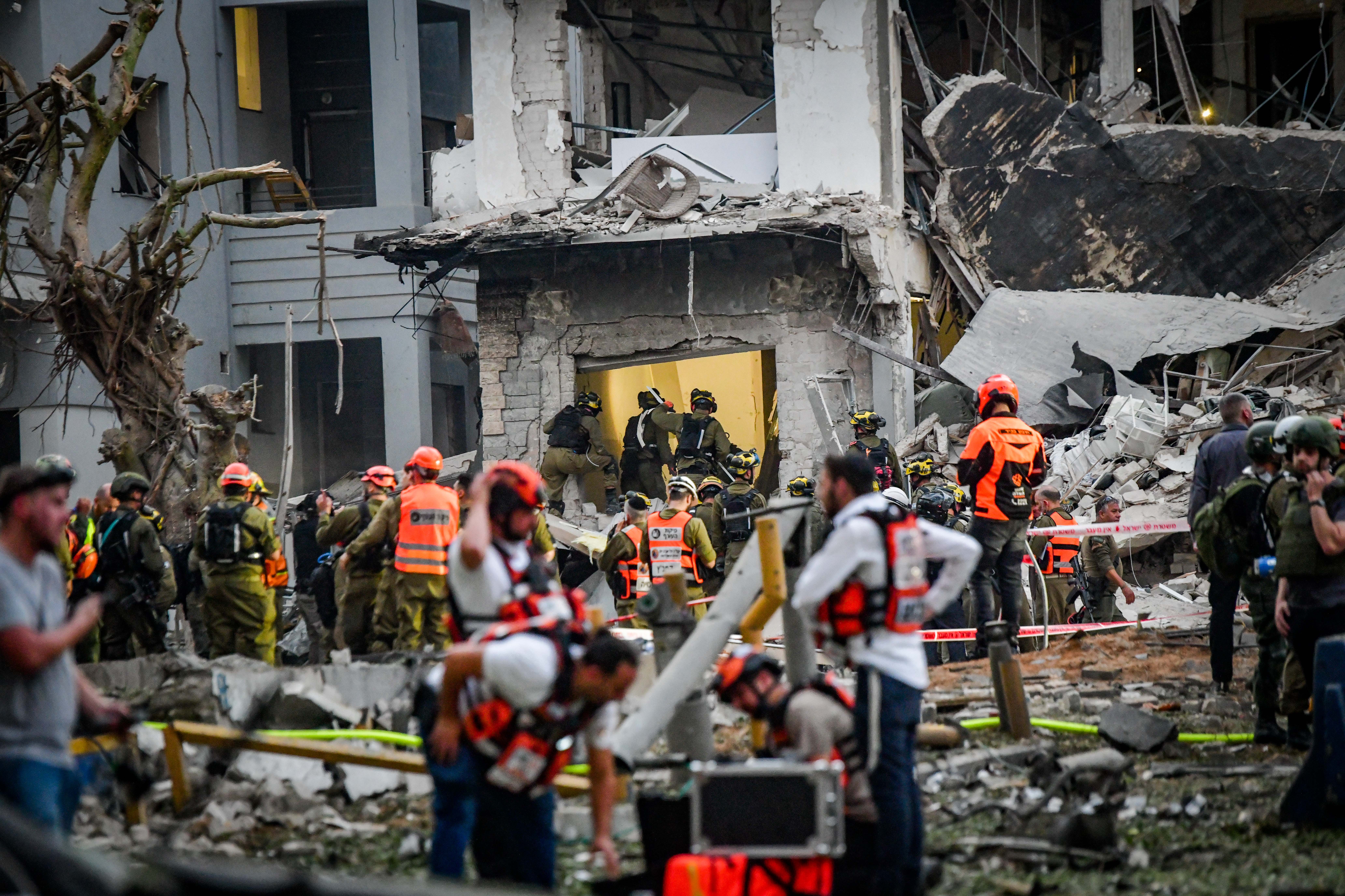  Israeli security and rescue forces at the scene where a ballistic missile fired from Iran hit and caused damage in Tel Aviv, June 17, 2025.  (photo credit: AVSHALOM SASSONI/FLASH90)