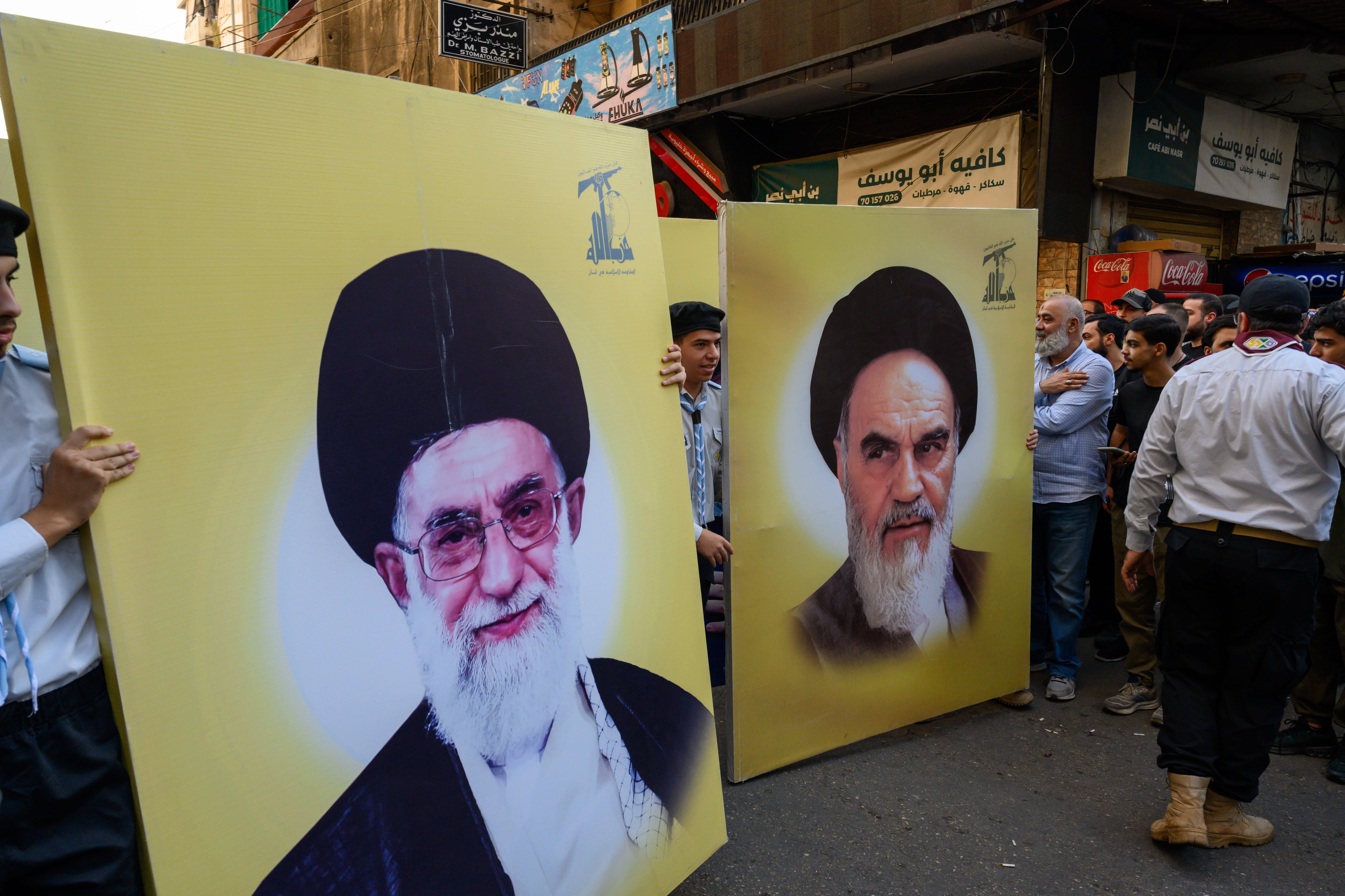 Hezbollah supporters carry banners of Iranian Supreme Leader Ali Khamenei (L) and his predecessor Ruhollah Khomenei (R) during a funeral march in Beirut, Lebanon, November 24, 2025; illustrative. (photo credit: Scott Peterson/Getty Images)