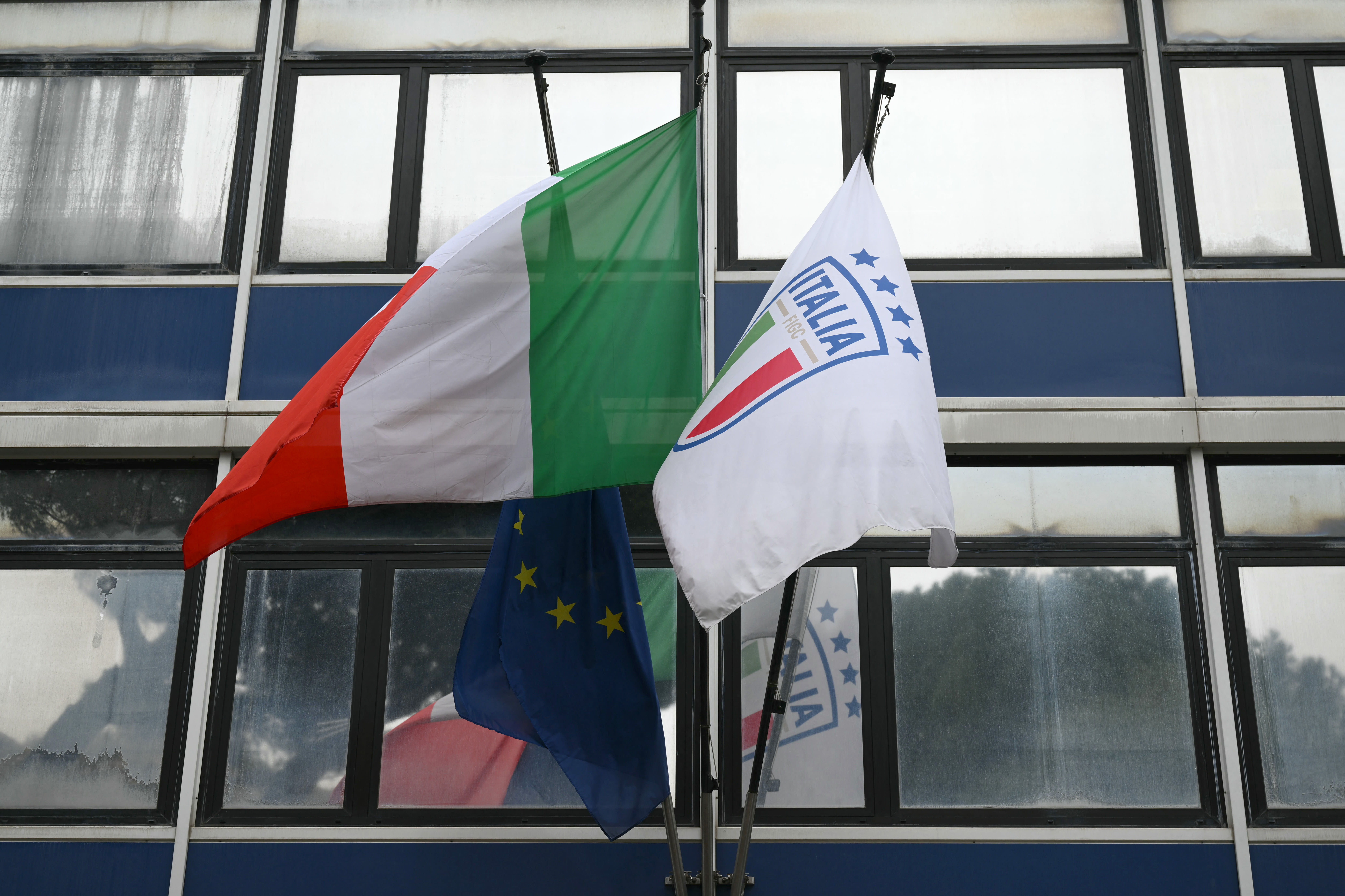 A picture shows flags of Italy and of the Italian Football Federation (FIGC) at the Italian Football Federation (FIGC) headquarters during a meeting of the Italian football authorities after the national team failed to qualify for a third consecutive World Cup, in Rome on April 2, 2026. (photo credit: Alberto PIZZOLI / AFP via Getty Images)