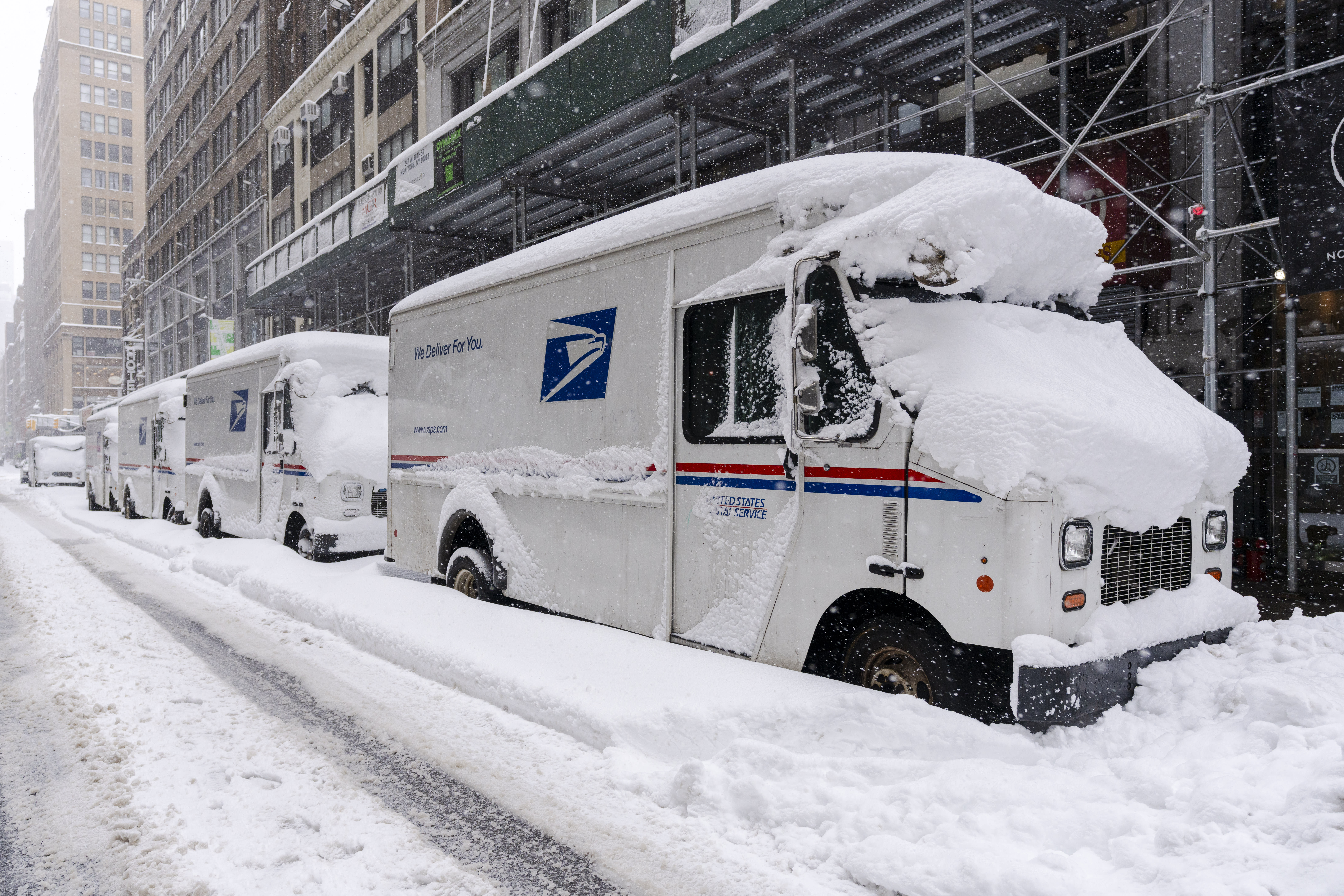 A view of USPS trucks after a day of heavy snowfall on February 23, 2026 in New York City. (photo credit: Craig T Fruchtman/Getty Images)