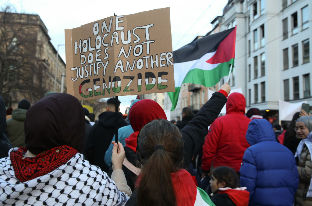 A protester holds a sign reading "One Holocaust Does Not Justify Another Genocide," with the last word written in German, as she attends a demonstration in support of Palestine on November 18, 2023 in Berlin, Germany. (photo credit: Adam Berry/Getty Images)