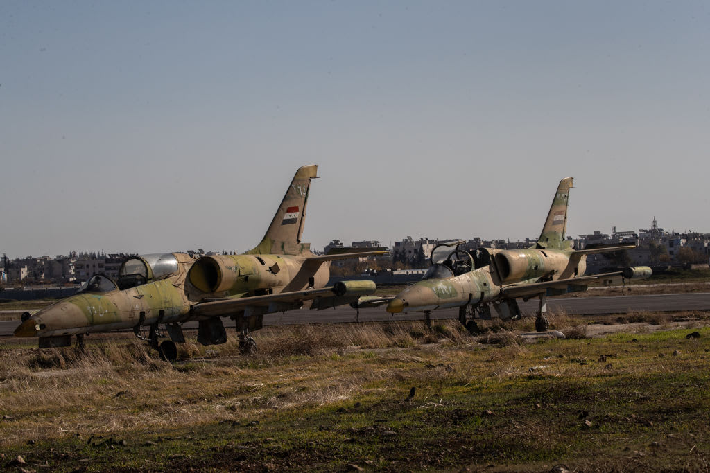 ABANDONED MILITARY jets are seen at the Aleppo airport on December 14, 2024 in Aleppo, Syria. Aleppo was the first major city to fall in last week