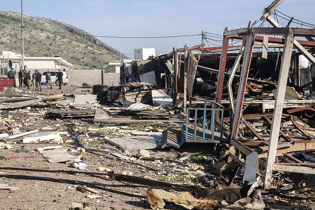 Illustrative: Komala party members look towards the debris is strewn from mangled structures following drone strikes on the Iranian Kurdish opposition Komala party