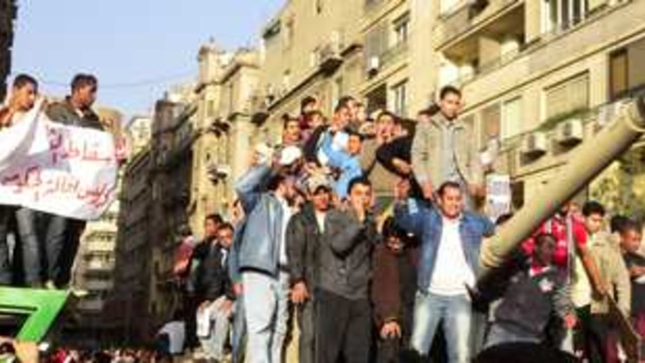 Egyptian protesters on tank 311