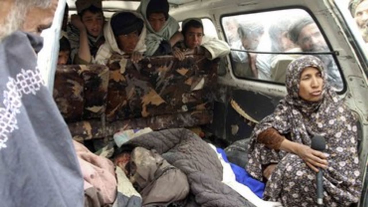 Afghan woman interviewed next to body of killed child_370