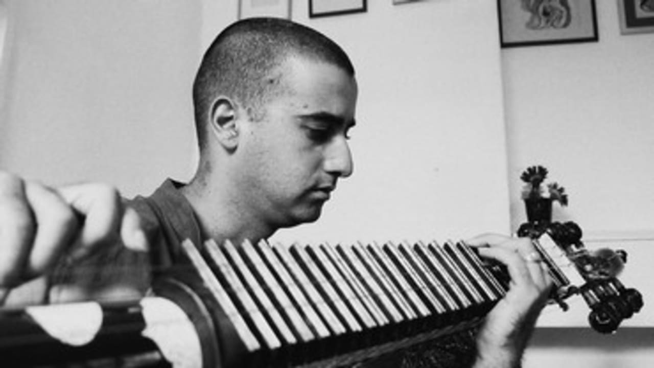 Indian man playing instrument 370