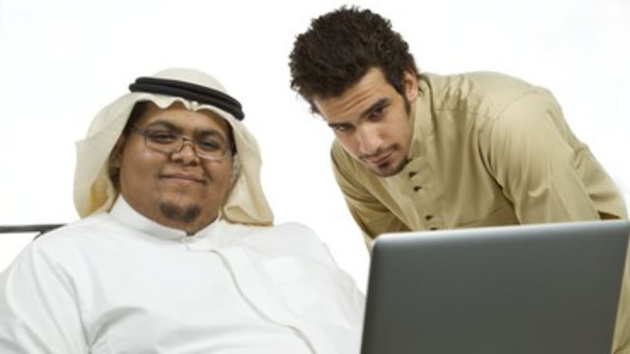 A large man sits with a computer 370
