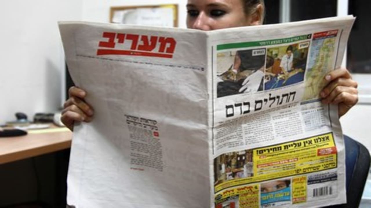 Woman reads Ma'ariv 370