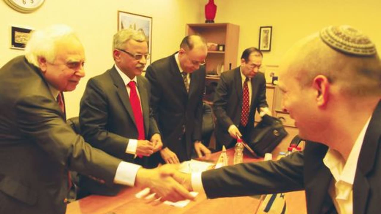 Kapil Sibal shakes hands with Naftali Bennett521