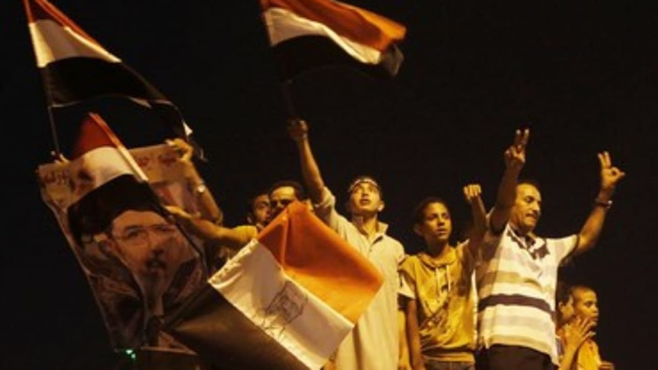 muslim brotherhood supporters wave flag at night 370