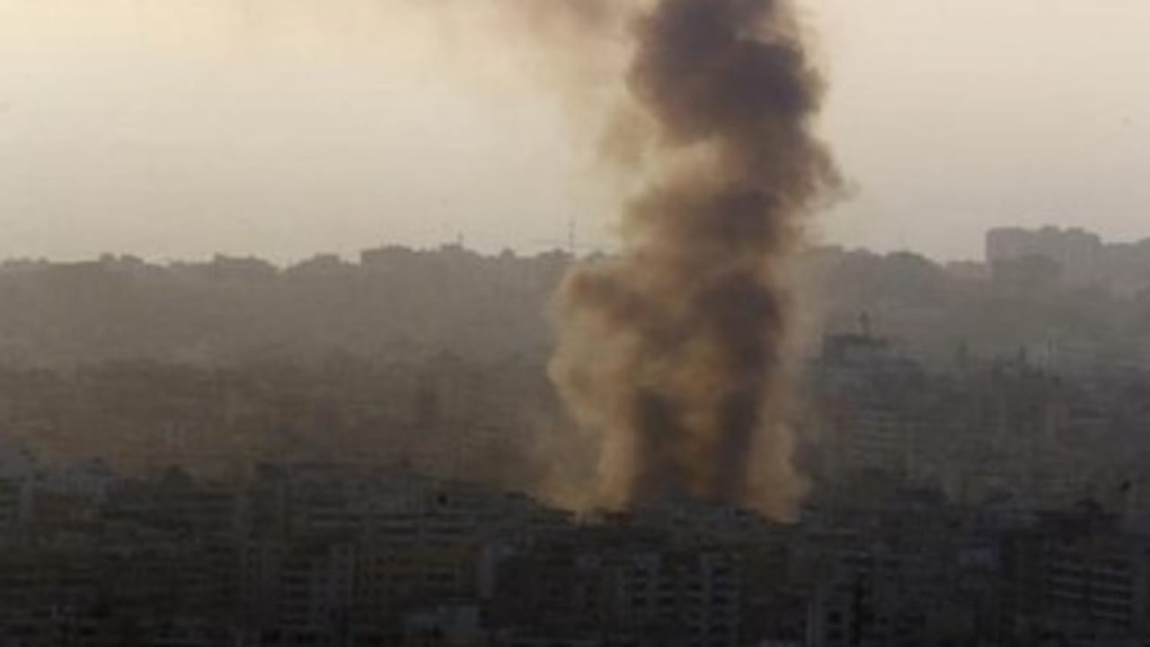 Smoke rises behind buildings in Beirut.