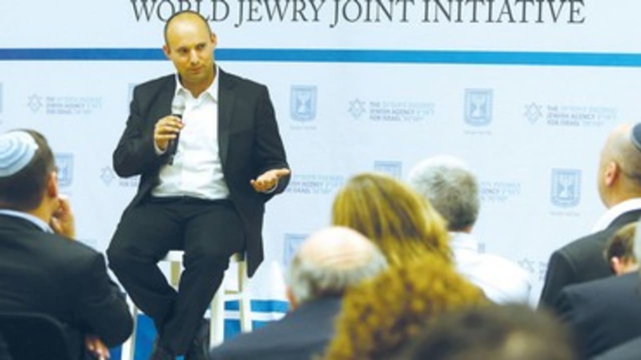 Naftali Bennett speaks to a forum on planning issue.
