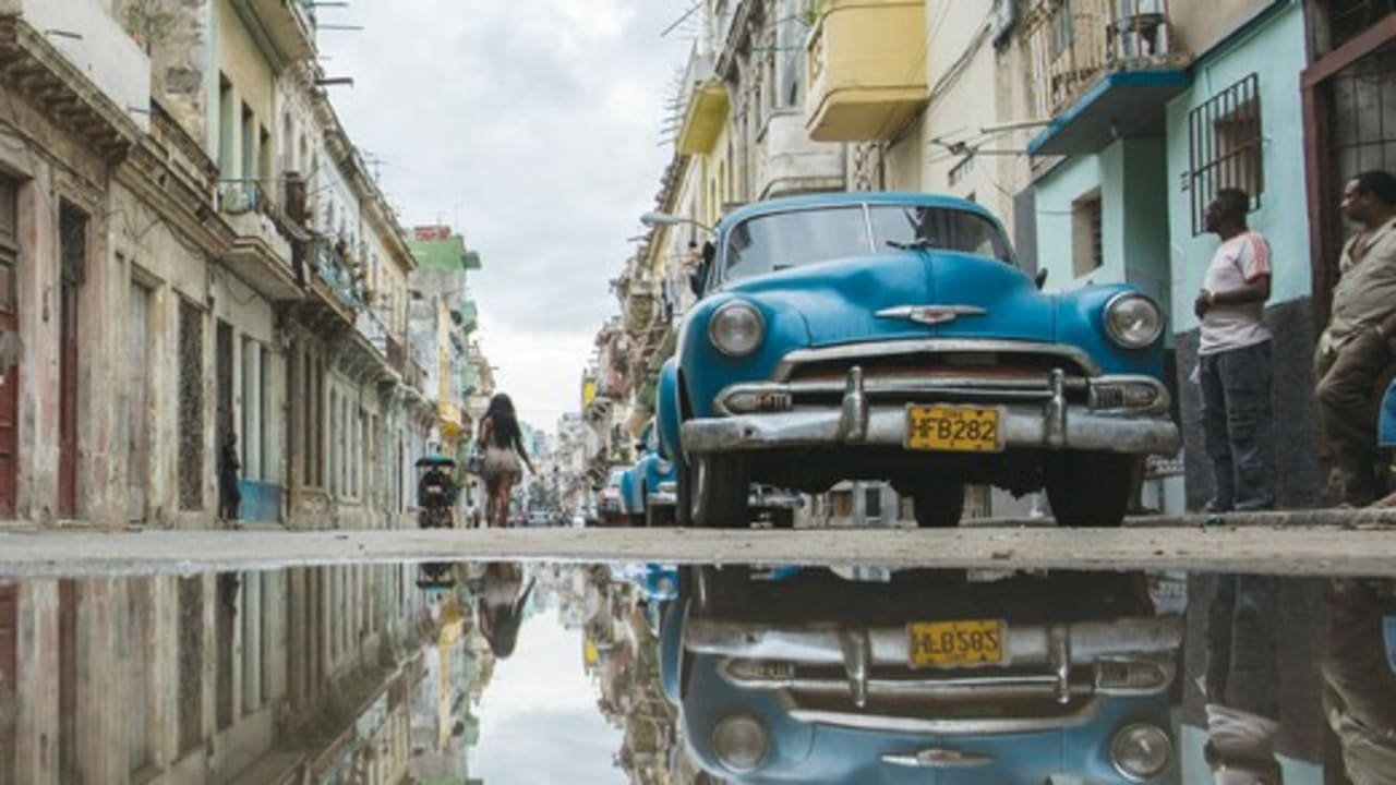 A STREET in Havana is reflected in a collection of water