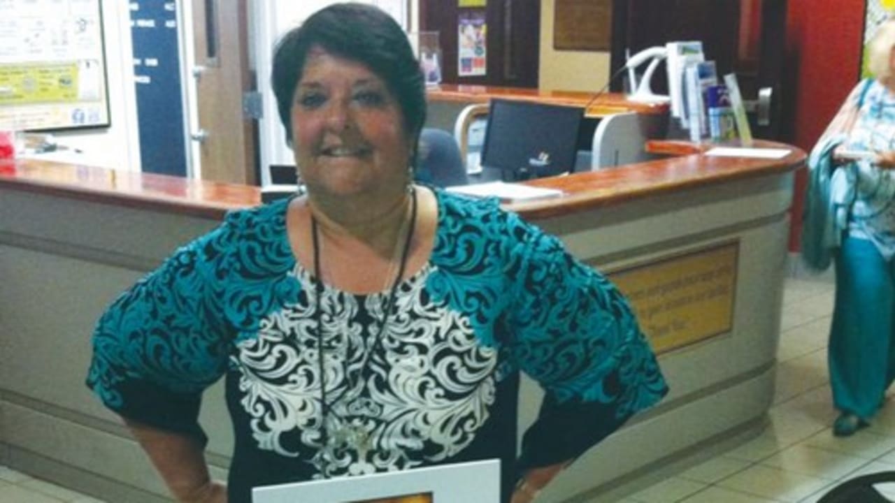 GENIE MILGROM poses with her book in Miami, Florida. 