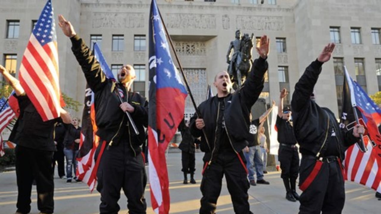 Members of the US National Socialist Movement salute during a neo-Nazi rally in Kansas City on the 75th anniversary of the Kristallnacht attack on Jews in Germany