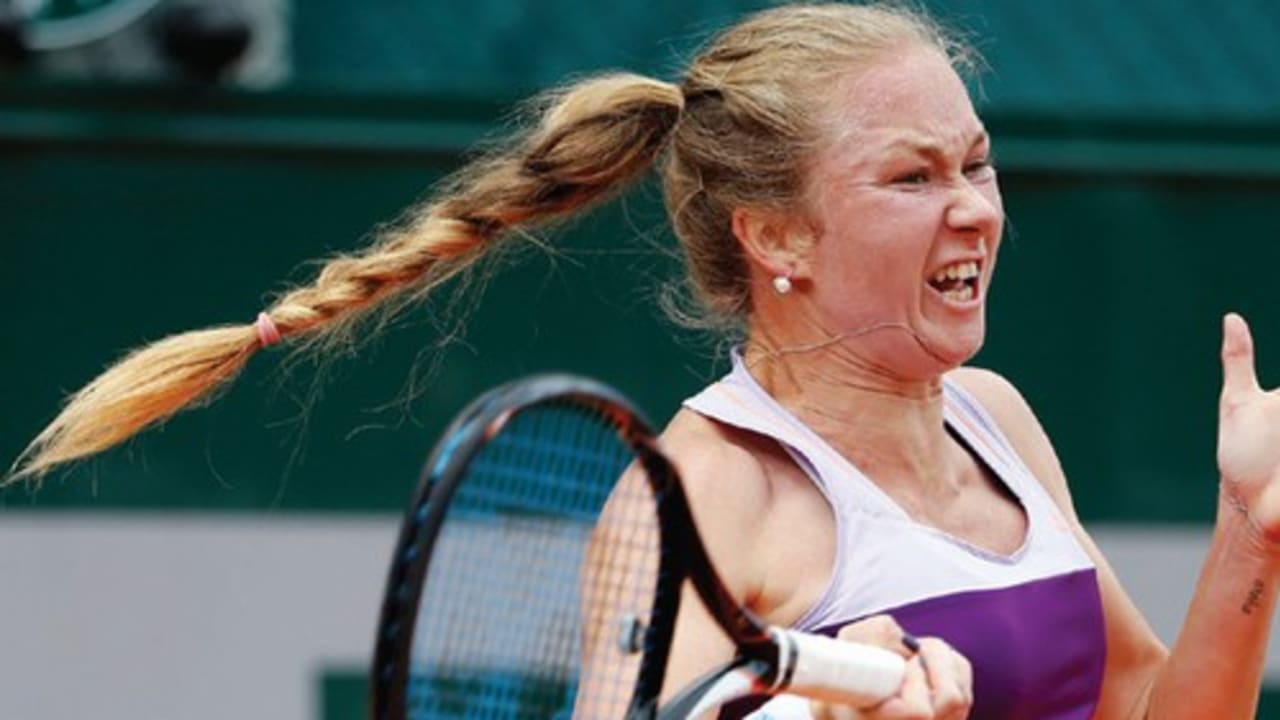 Julia Glushko of Israel returns to Kirsten Flipkens of Belgium during their second-round singles match yesterday at the French Open in Paris. Glushko matched her longest run at a Grand Slam by advancing with a 6-4, 3-6, 6-4 victory.