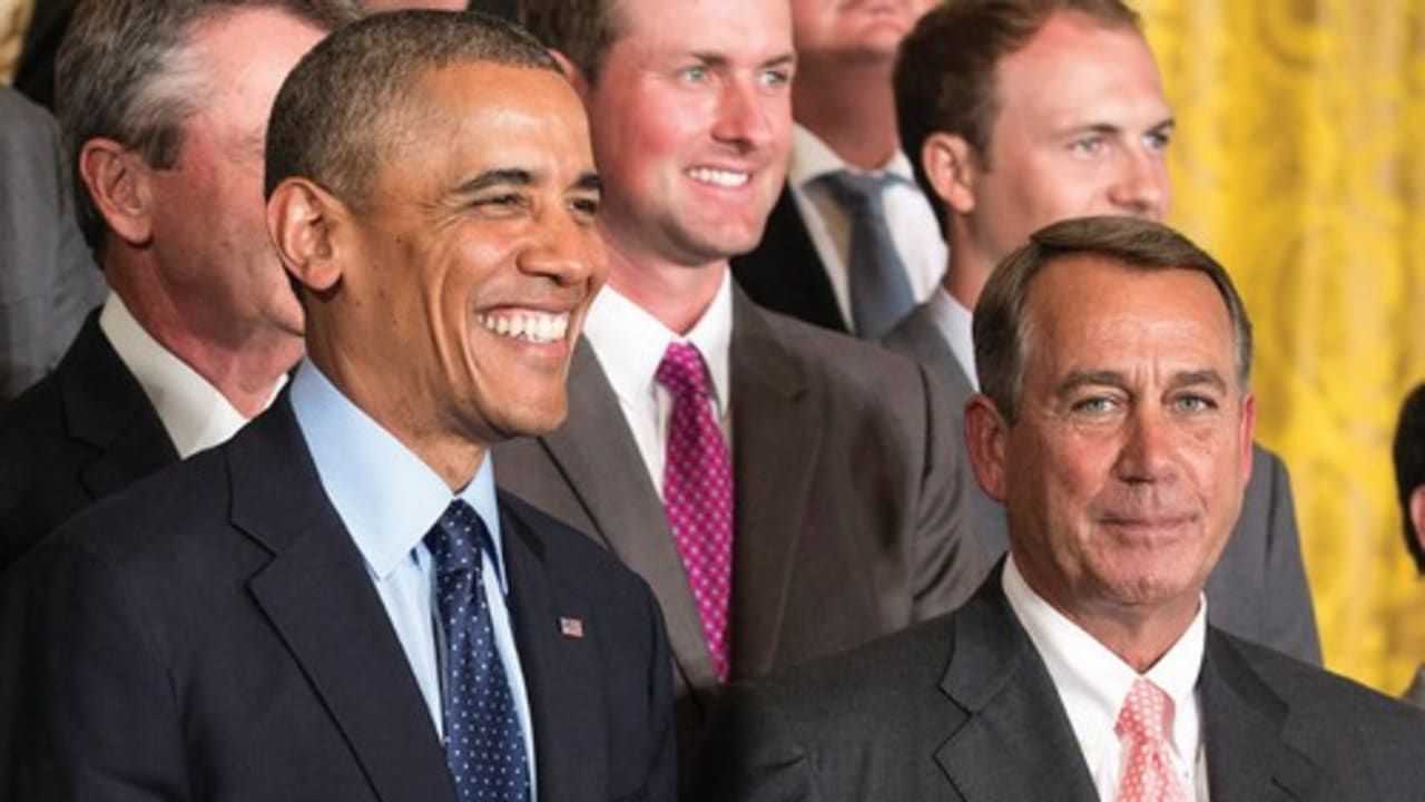 US President Barack Obama stands with Speaker of the House John Boehner during a ceremony honoring the President’s Cup golf teams in the East Room of the White House in Washington.